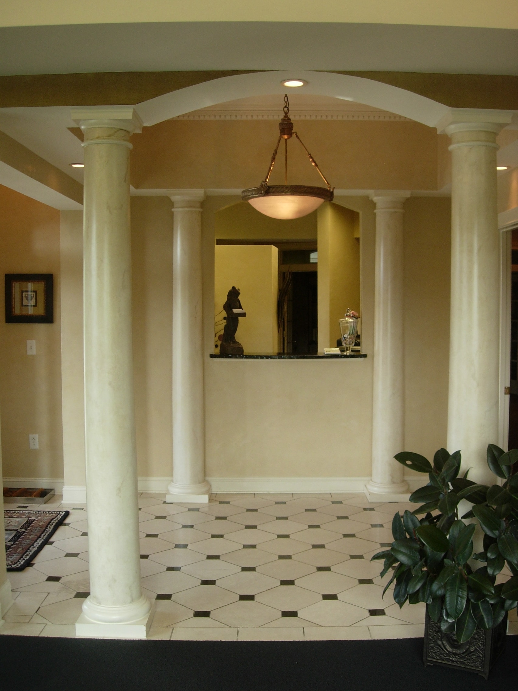Elegant reception area with classical columns and arched ceiling at Thomas H. Pitts DMD