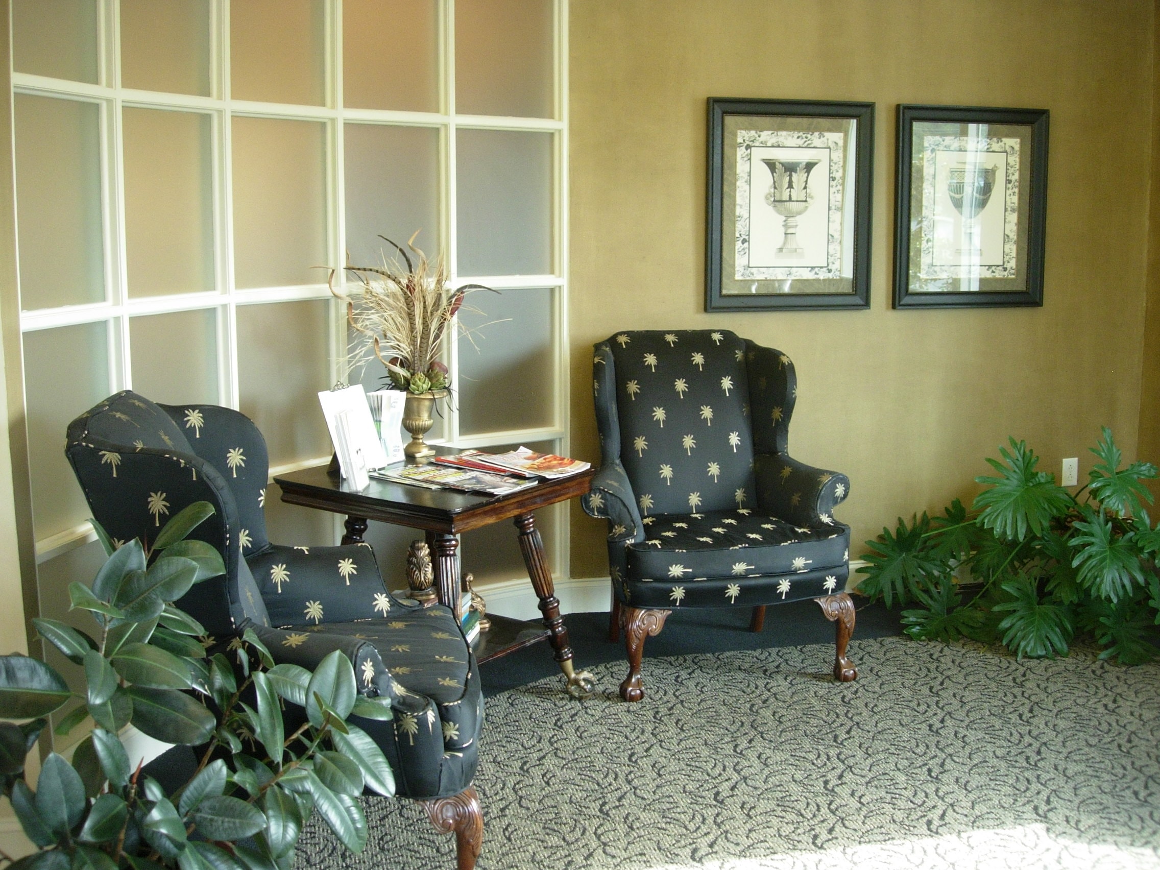 Comfortable waiting room seating area with classic wingback chairs at Thomas H. Pitts DMD